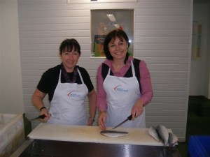 Carole-ann manager at STC, showing Anne how to fillet